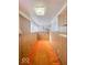 Long sunroom with wood paneling and orange carpeting at 1307 W Congress Ave, Indianapolis, IN 46208