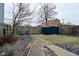 Backyard with a small shed, two blue chairs, and a walkway, creating a cozy outdoor space at 1719 Fletcher Ave, Indianapolis, IN 46203