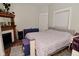 Charming bedroom with a decorative fireplace, warm wood floors, and soft natural light at 1719 Fletcher Ave, Indianapolis, IN 46203