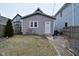 Gray single Gathering home featuring a side yard, a small garden, and a side entrance with a storm door at 1719 Fletcher Ave, Indianapolis, IN 46203