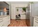 White cabinets with concrete countertops feature lots of closed storage in this modern kitchen at 1719 Fletcher Ave, Indianapolis, IN 46203