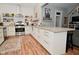 Open kitchen with subway tile backsplash, stainless steel range hood and large center island at 1719 Fletcher Ave, Indianapolis, IN 46203