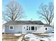 Ranch style home with gray siding, new windows, and a landscaped yard at 233 Howard St, Greenfield, IN 46140