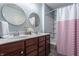 Shared bathroom with double vanity and striped shower curtain at 2342 The Springs Dr, Indianapolis, IN 46260