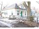 Side view of a white house with green door and snowy yard at 316 N Lasalle St, Indianapolis, IN 46201