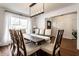 Bright dining room featuring a modern light fixture, a large window, and seating for eight at 333 S 4Th St, Zionsville, IN 46077