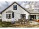 The home's backyard is showcased with a patio dining set, wicker furniture, string lights, and manicured landscape at 333 S 4Th St, Zionsville, IN 46077