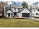 Charming two-story home boasts a well-manicured lawn, black trim, and attached two car garage at 333 S 4Th St, Zionsville, IN 46077