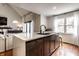 Open kitchen with marble countertops, dark wood cabinetry, and views into living room at 333 S 4Th St, Zionsville, IN 46077