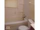 Small bathroom with a bathtub, toilet and single sink at 3726/3722/3716 N Emerson Ave, Indianapolis, IN 46218