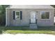 Tan brick house with a white door and black shutters at 3726/3722/3716 N Emerson Ave, Indianapolis, IN 46218