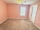 Bedroom featuring light pink walls, carpeting, and a window at 373 Brianne Ln, Danville, IN 46122