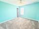Bright bedroom featuring fresh, turquoise-painted walls and plush, neutral carpeting at 373 Brianne Ln, Danville, IN 46122