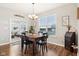 Bright dining room features a rustic wooden table and access to a sunroom at 373 Brianne Ln, Danville, IN 46122