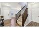 Inviting foyer features hardwood floors and a staircase with a wooden railing, leading to the upper level of the home at 373 Brianne Ln, Danville, IN 46122
