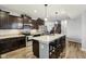 Modern kitchen features dark wood cabinets, stainless steel appliances, and a large center island with bar seating at 373 Brianne Ln, Danville, IN 46122