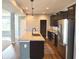 Modern kitchen with stainless appliances, dark cabinets, large island and adjacent to living room with lots of natural light at 373 Brianne Ln, Danville, IN 46122
