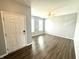 Bright, neutral living room with hardwood floors and a ceiling fan, adjacent to the home's front door at 373 Brianne Ln, Danville, IN 46122