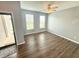Bright, neutral living room with hardwood floors and a ceiling fan, enhanced by natural light from two windows at 373 Brianne Ln, Danville, IN 46122