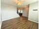 Open-concept living room with hardwood floors leads to a staircase and glimpses of a modern kitchen at 373 Brianne Ln, Danville, IN 46122