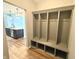 This mudroom features built-in shelving, storage and hooks next to an open concept kitchen at 373 Brianne Ln, Danville, IN 46122