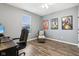 Home office with wood desk, comfortable chair, and hardwood floors at 373 Brianne Ln, Danville, IN 46122