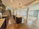 Open concept kitchen with island seating flows into the adjacent living room and nearby staircase and foyer at 373 Brianne Ln, Danville, IN 46122