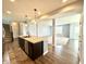 Open concept kitchen with island seating flows into the adjacent living room and nearby staircase and foyer at 373 Brianne Ln, Danville, IN 46122