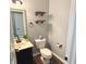 Stylish powder room features modern fixtures, a sleek vanity, and decorative shelves for a touch of elegance at 373 Brianne Ln, Danville, IN 46122