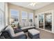 Cozy sunroom featuring wicker seating and sliding glass doors to the outside at 373 Brianne Ln, Danville, IN 46122