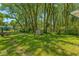 Spacious backyard featuring mature trees, a shed, and a well-maintained lawn at 3816 Rookwood Ave, Indianapolis, IN 46208