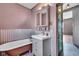 Charming bathroom with clawfoot tub, updated vanity, and corrugated metal accents at 3816 Rookwood Ave, Indianapolis, IN 46208