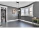 Bright dining room features an exposed brick wall, hardwood floors, and a view into the kitchen at 3816 Rookwood Ave, Indianapolis, IN 46208