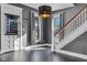 Bright entryway with gray walls, hardwood floors, and staircase at 3816 Rookwood Ave, Indianapolis, IN 46208