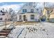 Charming white house with a front porch, steps, and snow-covered lawn at 3816 Rookwood Ave, Indianapolis, IN 46208