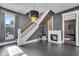 Spacious living room with fireplace, hardwood floors, and staircase at 3816 Rookwood Ave, Indianapolis, IN 46208