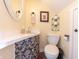 Small bathroom with pedestal sink, toilet, and decorative details at 4042 E Clover St, Columbus, IN 47203