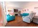 Living room with hardwood floors, teal sofas, and a fireplace at 4042 E Clover St, Columbus, IN 47203