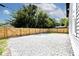 Gravel backyard with wood fence and mature trees at 459 N Concord St, Indianapolis, IN 46222