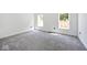 Bright bedroom with grey carpet and two large windows at 459 N Concord St, Indianapolis, IN 46222