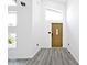Bright entryway with wood door, gray vinyl flooring, and high ceilings at 459 N Concord St, Indianapolis, IN 46222
