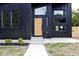 Modern black exterior with wood-toned front door and walkway at 459 N Concord St, Indianapolis, IN 46222