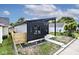 Stylish house with gray and black siding, a wooden fence, and landscaping at 459 N Concord St, Indianapolis, IN 46222
