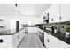 Modern kitchen with white cabinets, granite countertops, and stainless steel appliances at 459 N Concord St, Indianapolis, IN 46222