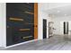 Modern living room featuring a unique wood and black accent wall, hardwood floors, and an open floor plan at 459 N Concord St, Indianapolis, IN 46222