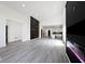 Open concept living room with gray floors, black accent wall, and kitchen view at 459 N Concord St, Indianapolis, IN 46222