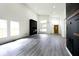 Open living area with gray floors, a black accent wall, and natural light at 459 N Concord St, Indianapolis, IN 46222