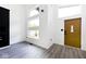 Open living space with gray vinyl floors and large windows at 459 N Concord St, Indianapolis, IN 46222
