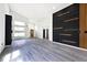 Modern living room with gray floors, black and wood feature wall, and kitchen access at 459 N Concord St, Indianapolis, IN 46222