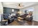 Living room with dark-colored reclining sofas and a wood-look floor at 4817 W Quail Run W Dr, New Palestine, IN 46163